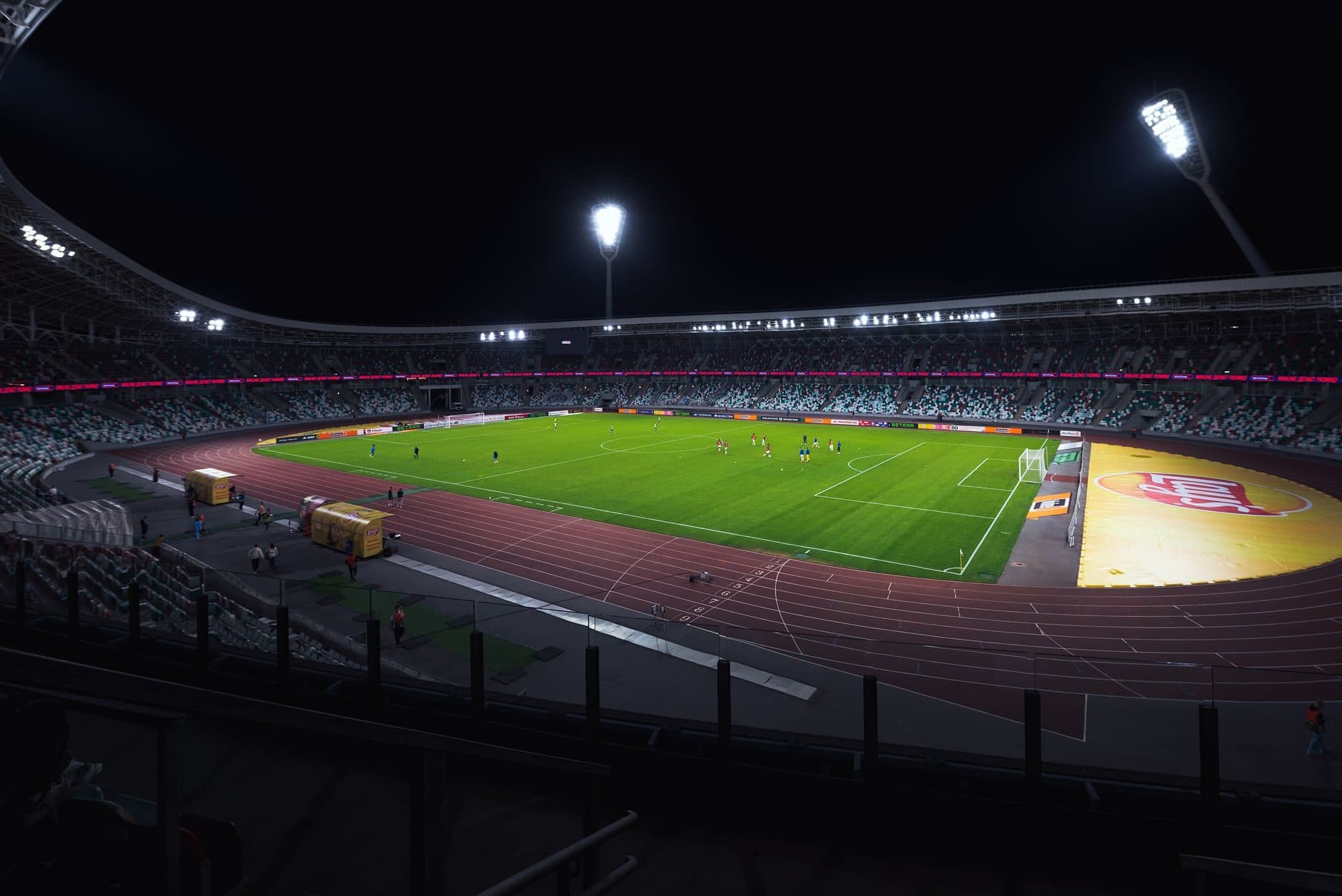 A floodlit stadium at night before a match